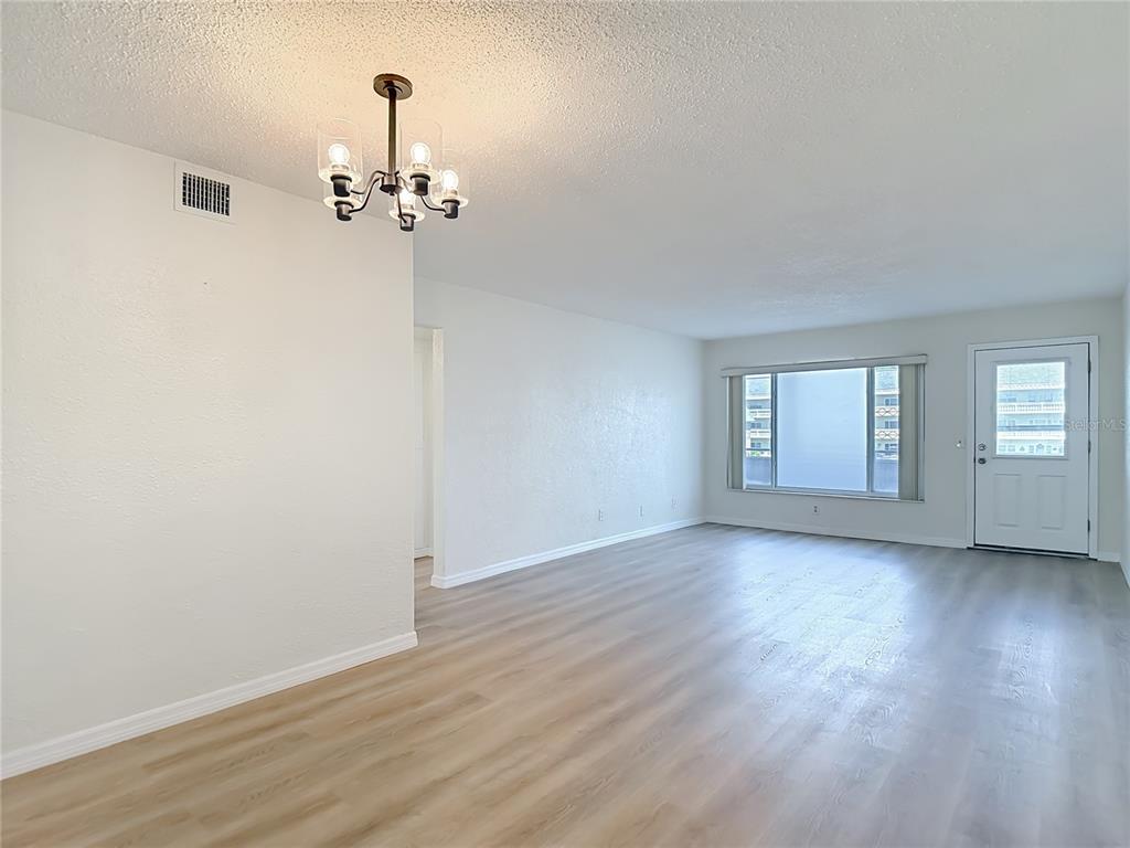 2461 Canadian Way, Unit 45 Clearwater, FL 33763 - Photo 9 of 33 wooden floor in an empty room with a window