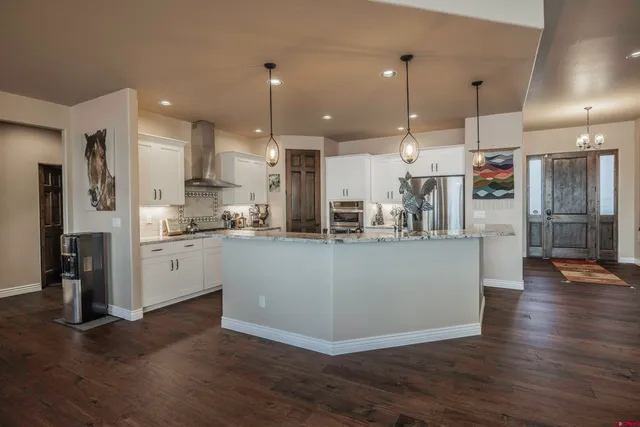 a view of a kitchen and kitchen with stainless steel appliances