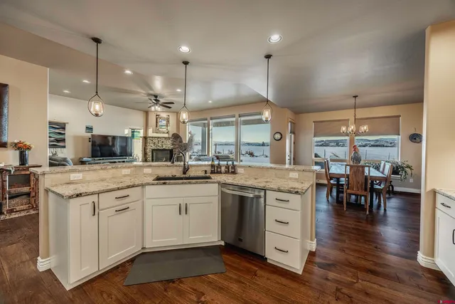 a large kitchen with stainless steel appliances granite countertop a sink stove and refrigerator