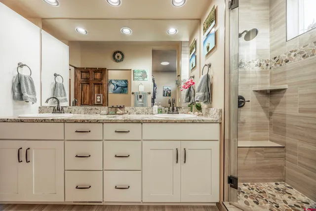 a kitchen with a sink a refrigerator and cabinets