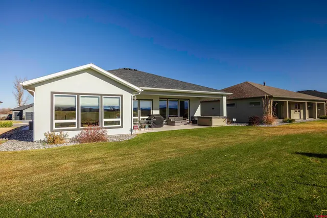 a view of a house with a swimming pool and a yard