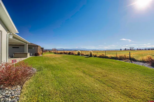 a view of a house with swimming pool and sitting area