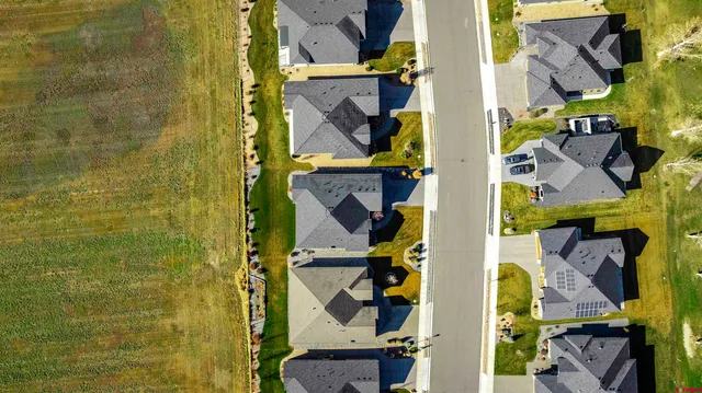 an aerial view of residential houses with outdoor space