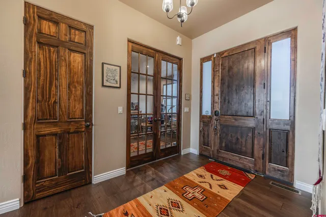a view of a hallway with wooden floor and windows
