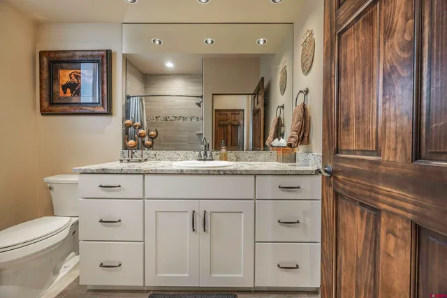 a bathroom with a sink vanity and a mirror