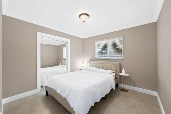 a bathroom with a granite countertop sink a mirror and a bathtub