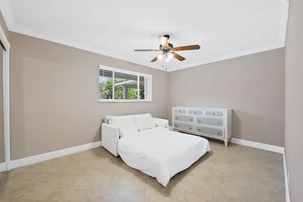 a view of a patio with table and chairs potted plants and palm tree