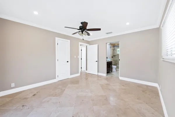 a view of a house with a yard and potted plants
