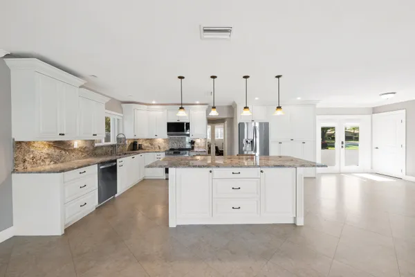 a bedroom with a bed and closet with wooden floor