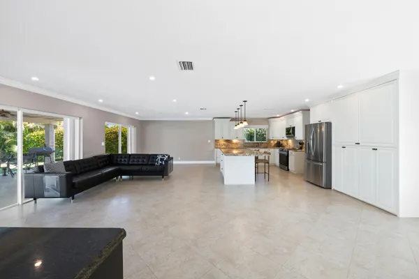 a bathroom with a granite countertop sink toilet mirror and shower