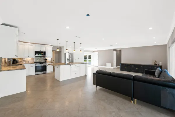 a bedroom with a bed couch and a ceiling fan