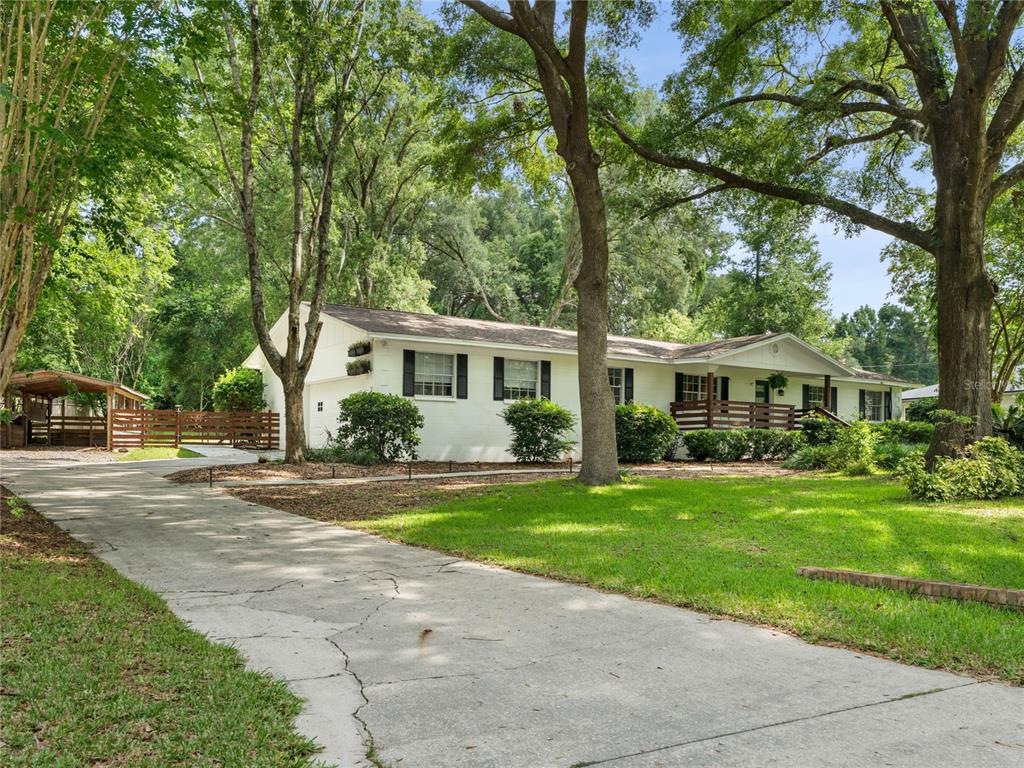 8024 Northwest 2nd Court Gainesville, FL 32607 - Photo 1 of 40 a front view of a house with a garden