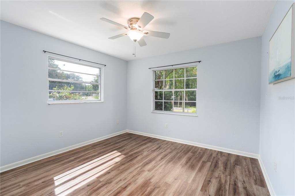 8024 Northwest 2nd Court Gainesville, FL 32607 - Photo 12 of 40 a view of an empty room with wooden floor and a window