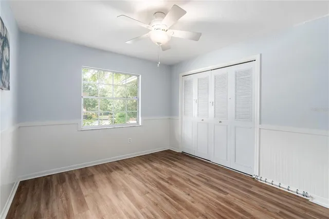 a view of a room with a ceiling fan and a window