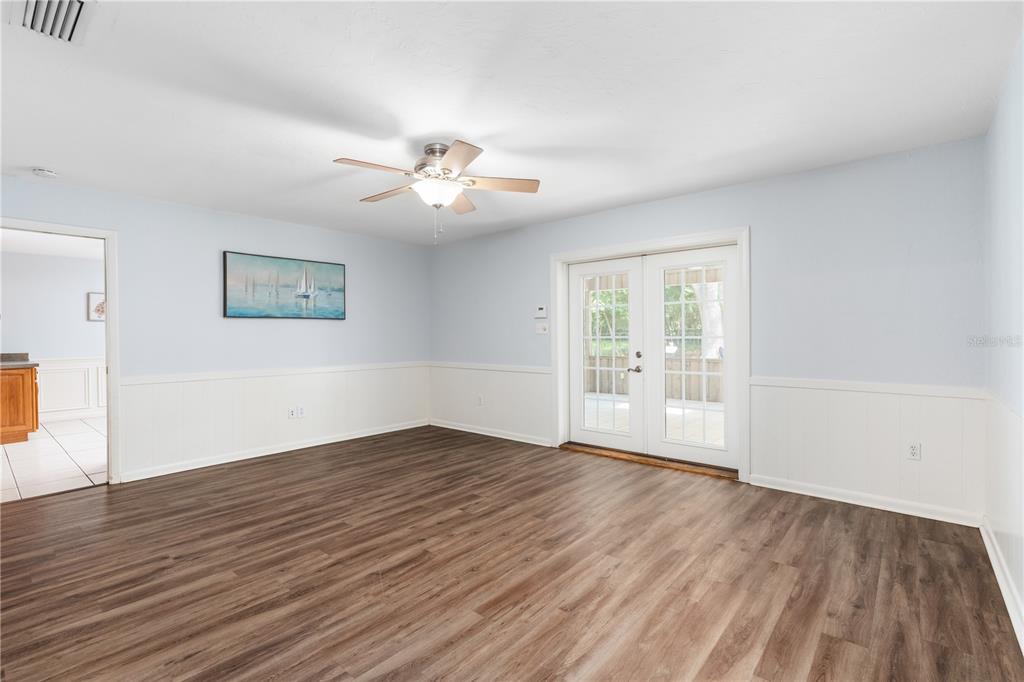 8024 Northwest 2nd Court Gainesville, FL 32607 - Photo 18 of 40 a view of an empty room with wooden floor and a window