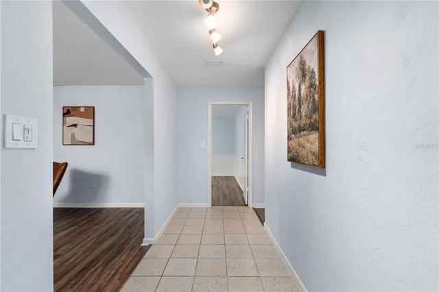 a view of entryway and hall with wooden floor