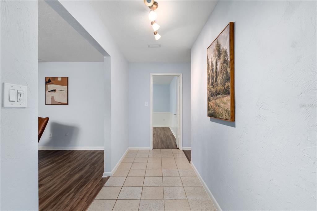 8024 Northwest 2nd Court Gainesville, FL 32607 - Photo 20 of 40 a view of entryway and hall with wooden floor