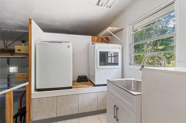 a kitchen with a window a sink and a refrigerator