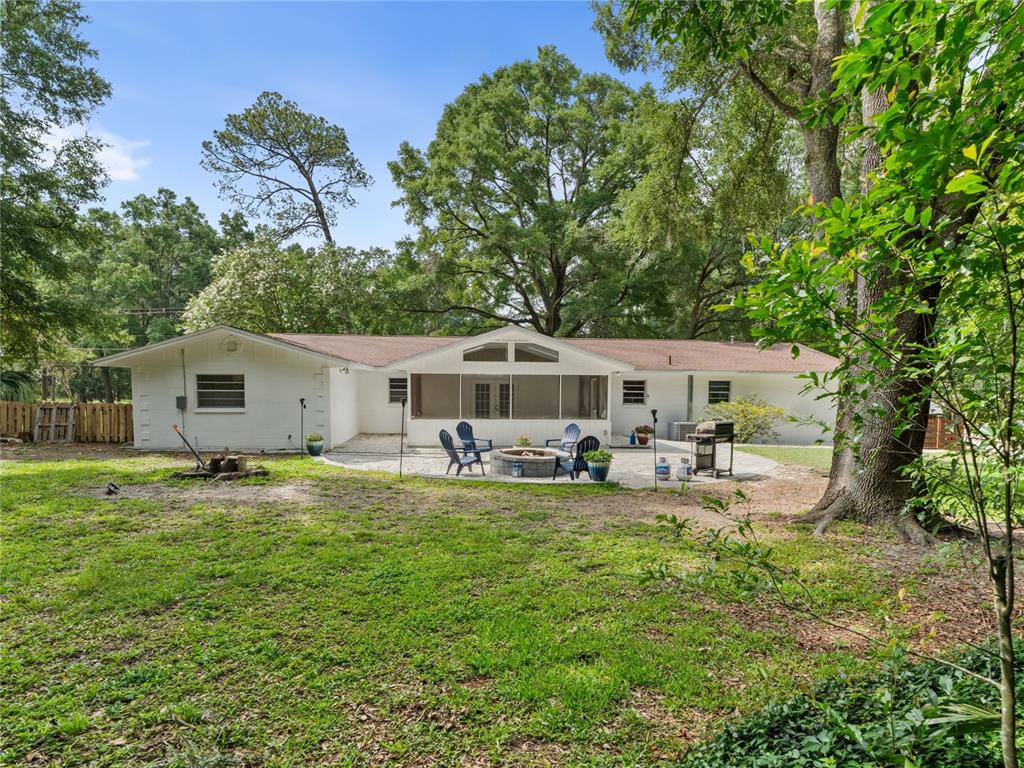 8024 Northwest 2nd Court Gainesville, FL 32607 - Photo 30 of 40 a view of a house with backyard sitting area and garden