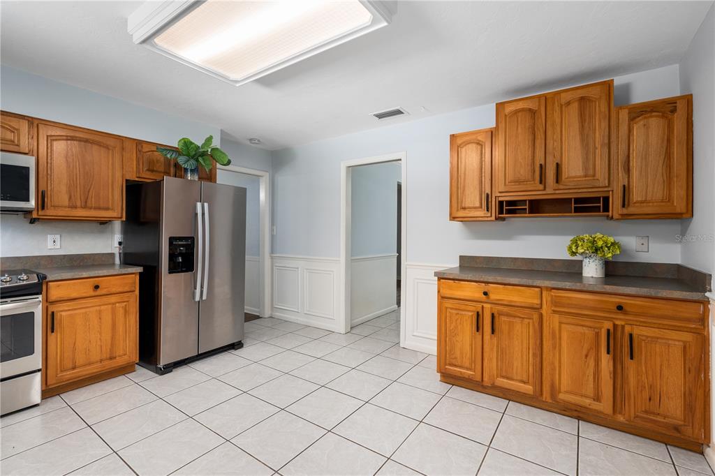 8024 Northwest 2nd Court Gainesville, FL 32607 - Photo 4 of 40 a kitchen with stainless steel appliances granite countertop a refrigerator sink and microwave