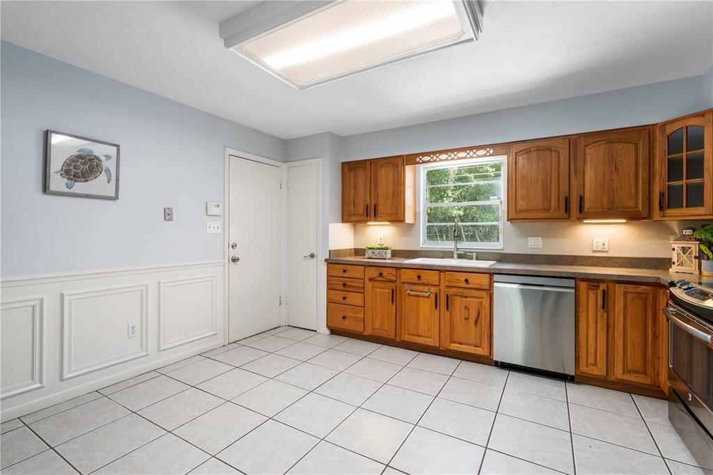 8024 Northwest 2nd Court Gainesville, FL 32607 - Photo 5 of 40 a kitchen with stainless steel appliances granite countertop a stove sink and cabinets