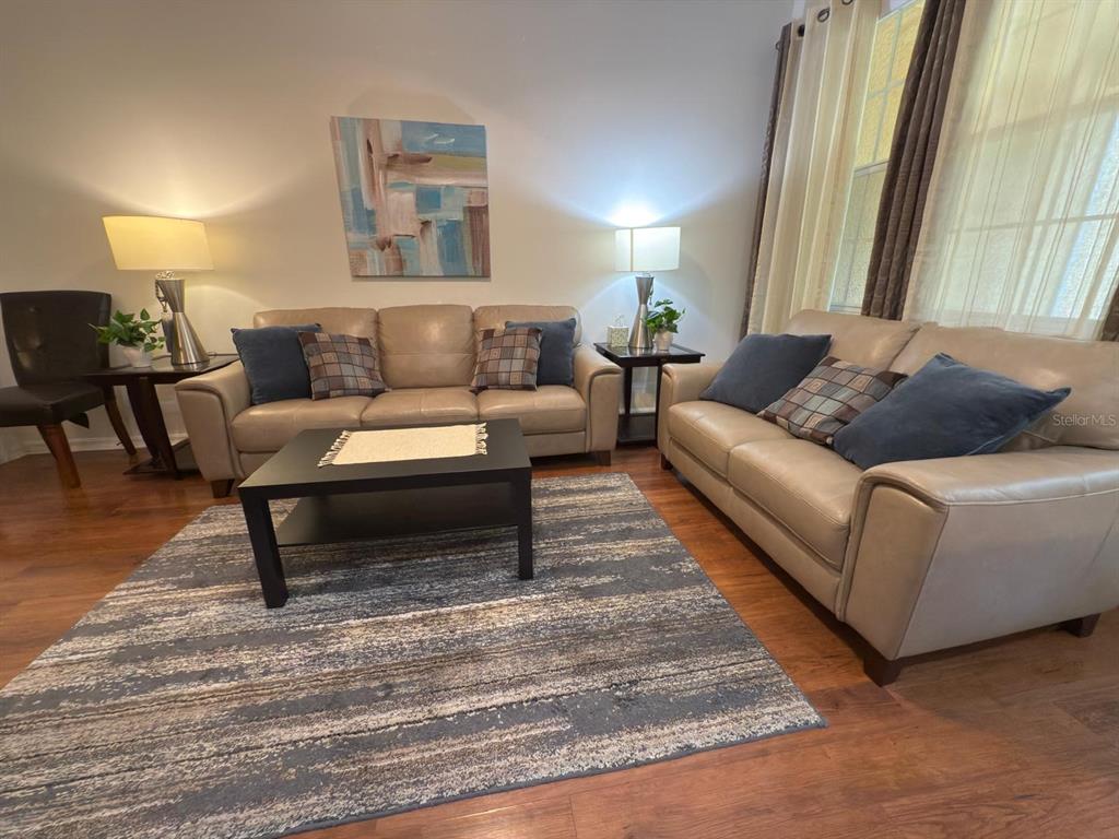 879 Assembly Court Reunion, FL 34747 - Photo 16 of 46 a living room with furniture and a rug
