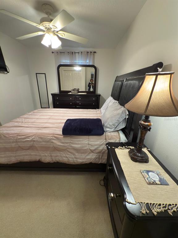 879 Assembly Court Reunion, FL 34747 - Photo 20 of 46 a bedroom with a bed and a chandelier