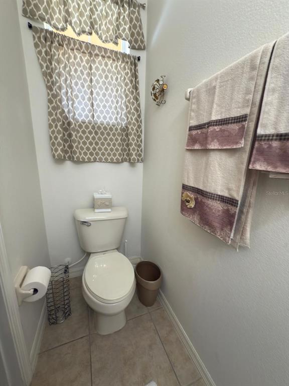 879 Assembly Court Reunion, FL 34747 - Photo 22 of 46 a white toilet sitting next to a shower