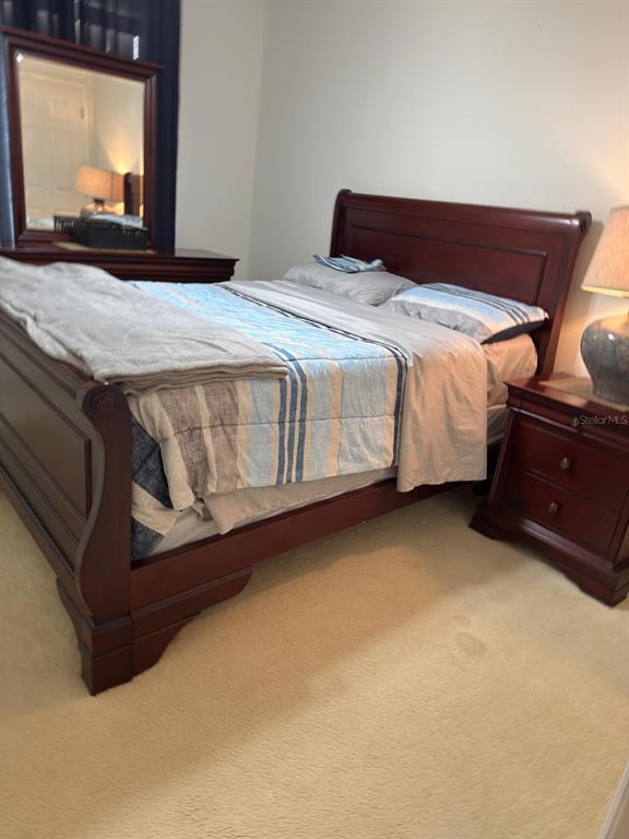 879 Assembly Court Reunion, FL 34747 - Photo 24 of 46 a bedroom with a bed and window with chair