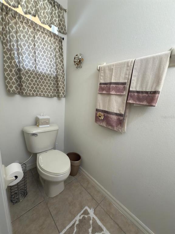 879 Assembly Court Reunion, FL 34747 - Photo 25 of 46 a bathroom with a toilet and a shower curtain