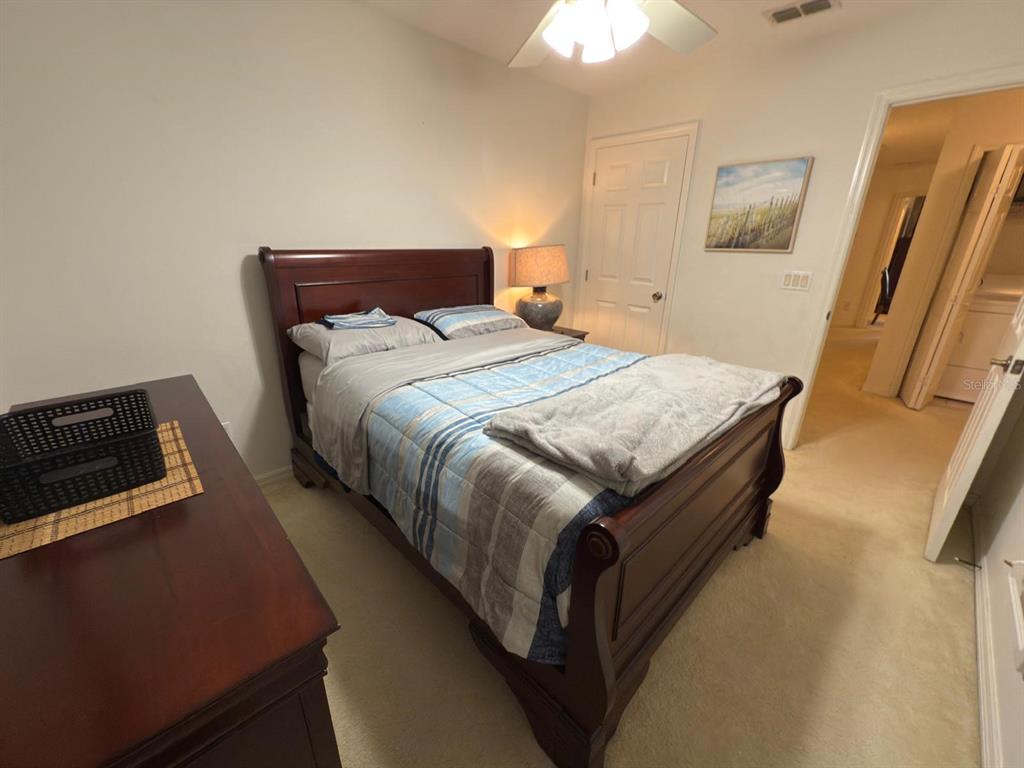 879 Assembly Court Reunion, FL 34747 - Photo 27 of 46 a bed sitting in a bedroom next to a window