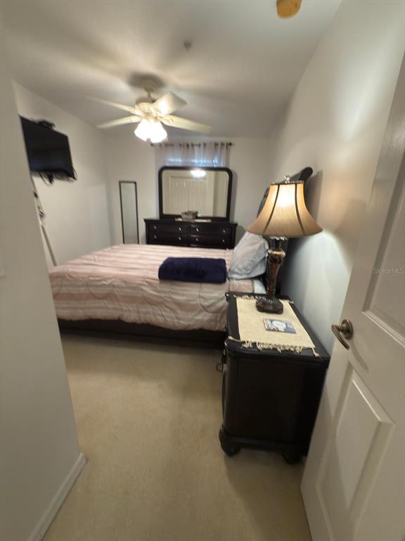 879 Assembly Court Reunion, FL 34747 - Photo 28 of 46 a bedroom with a bed and a chandelier
