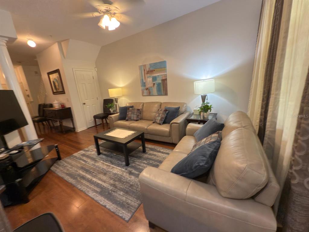 879 Assembly Court Reunion, FL 34747 - Photo 3 of 46 a living room with furniture and a chandelier