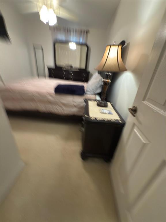 879 Assembly Court Reunion, FL 34747 - Photo 31 of 46 a bedroom with a bed and a lamp