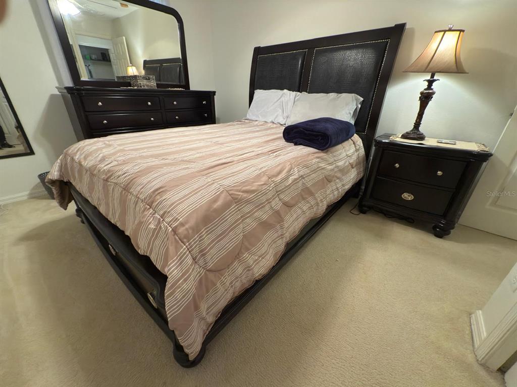 879 Assembly Court Reunion, FL 34747 - Photo 32 of 46 a bedroom with a bed and lamp on table