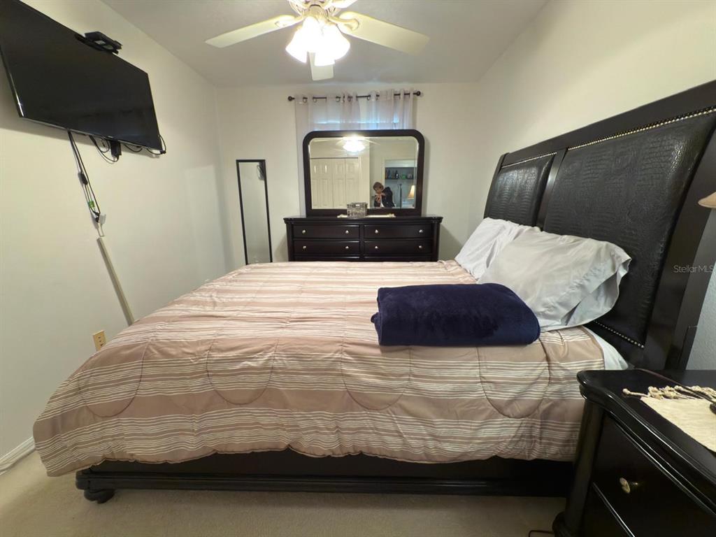 879 Assembly Court Reunion, FL 34747 - Photo 35 of 46 a bedroom with a bed and a mirror