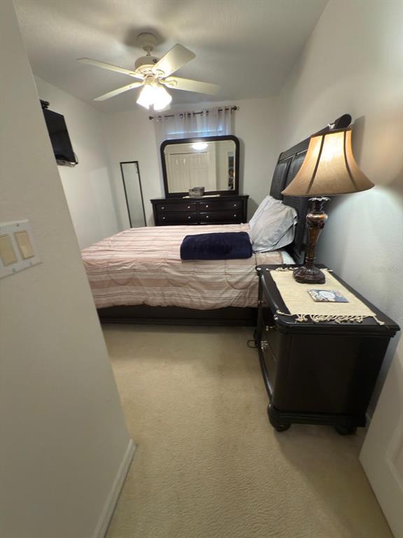 879 Assembly Court Reunion, FL 34747 - Photo 37 of 46 a bedroom with bed and window with lamp