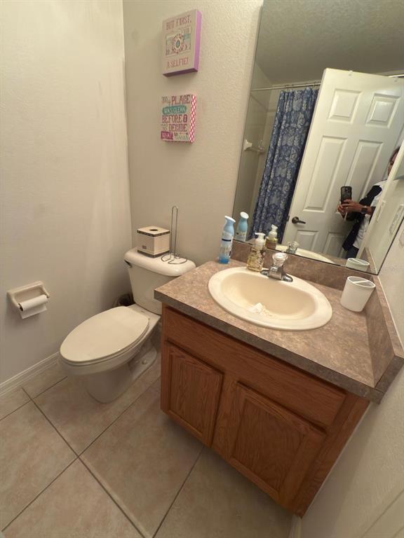 879 Assembly Court Reunion, FL 34747 - Photo 40 of 46 a bathroom with a sink a toilet and mirror