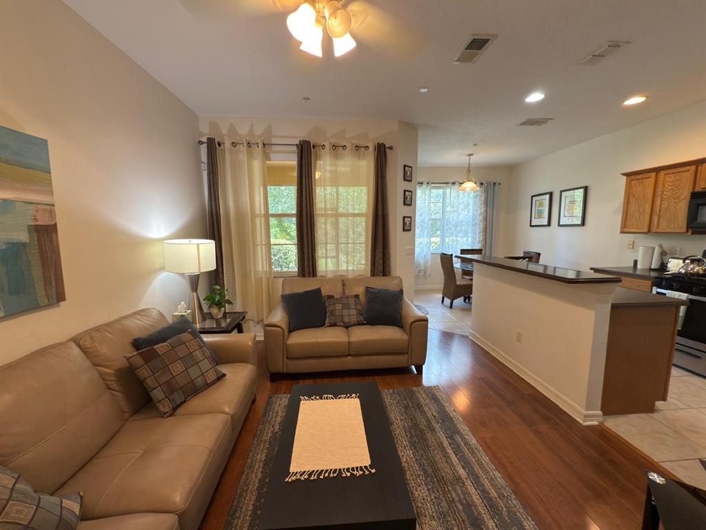 879 Assembly Court Reunion, FL 34747 - Photo 4 of 46 a living room with furniture and a large window