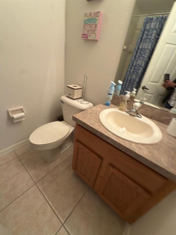 879 Assembly Court Reunion, FL 34747 - Photo 42 of 46 a bathroom with a sink toilet and a mirror