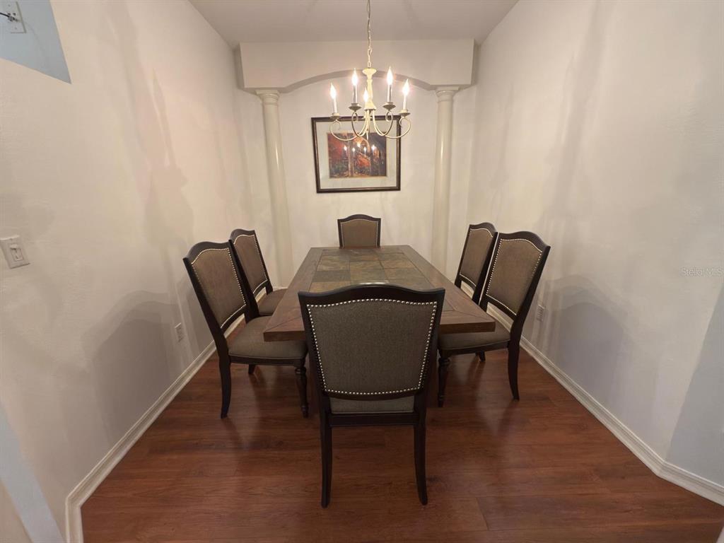 879 Assembly Court Reunion, FL 34747 - Photo 7 of 46 a view of a workspace with furniture and chandelier