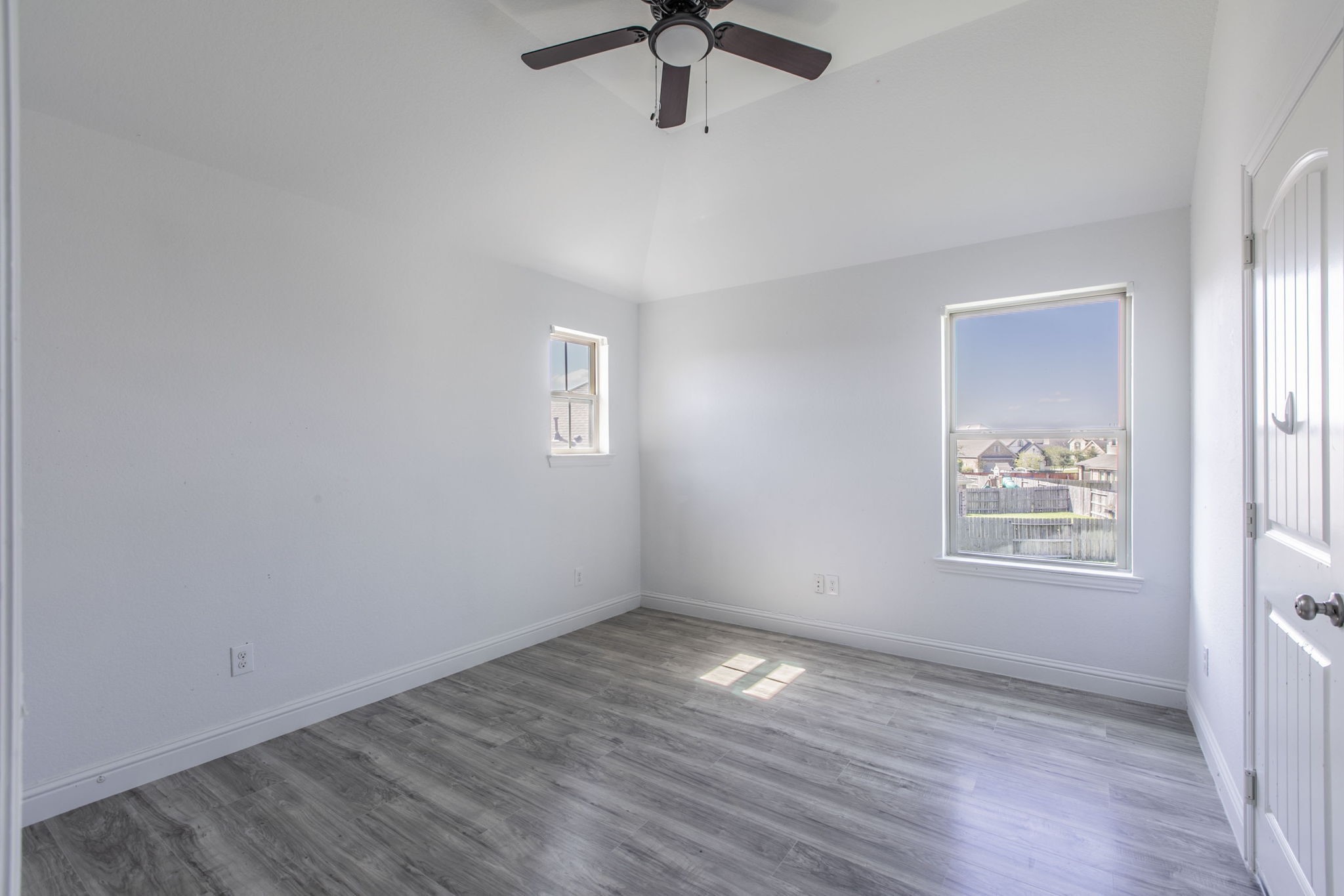 4806 Timber Gate Court Rosharon, TX 77583 - Photo 11 of 36 a view of an empty room with a window and wooden floor