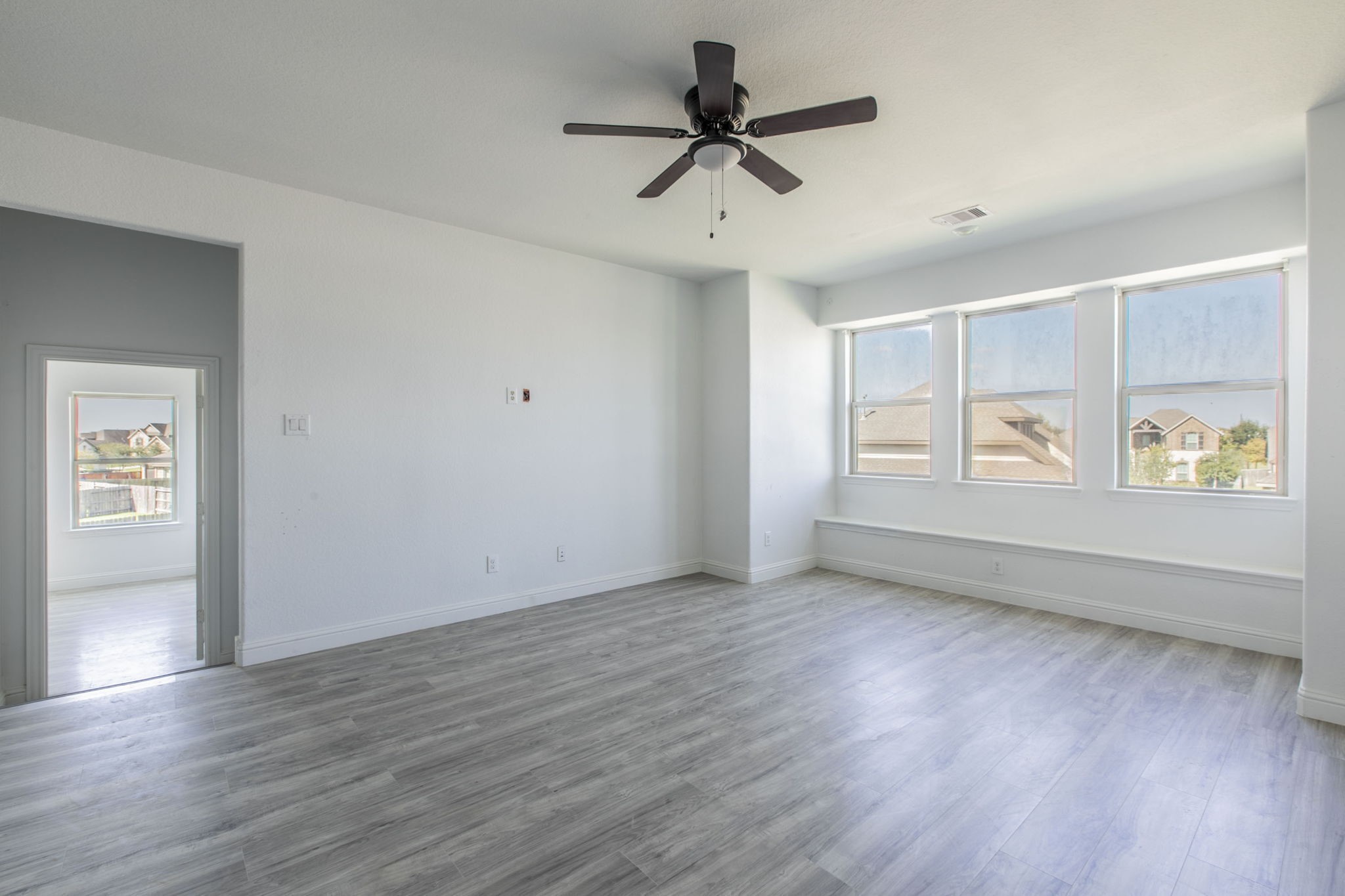 4806 Timber Gate Court Rosharon, TX 77583 - Photo 12 of 36 a view of an empty room with a window and wooden floor