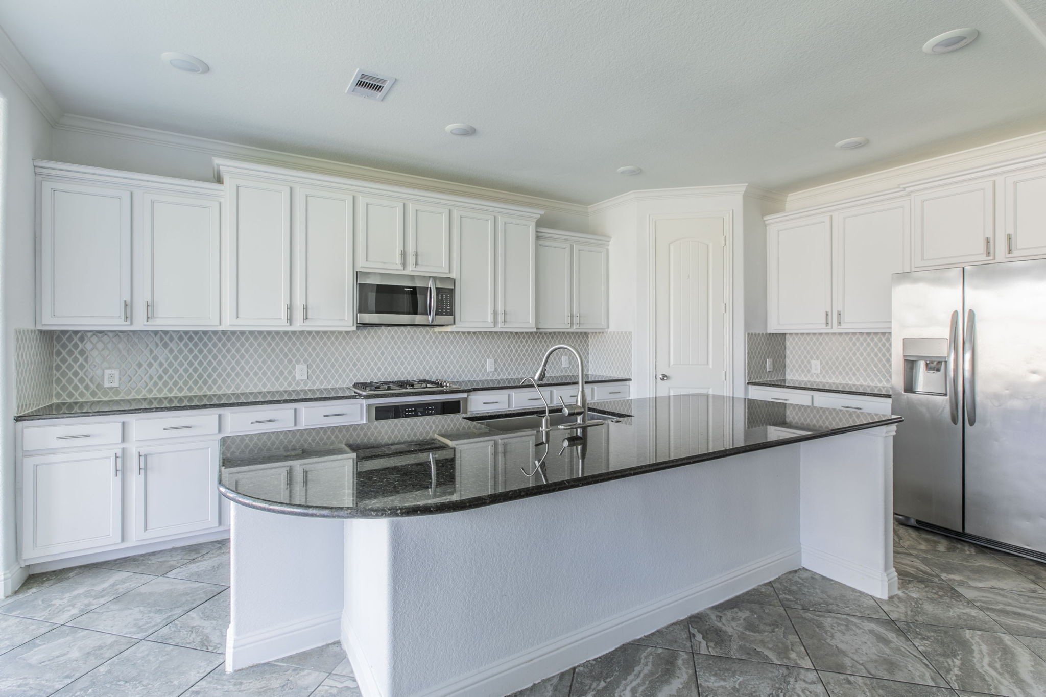 4806 Timber Gate Court Rosharon, TX 77583 - Photo 16 of 36 a kitchen with stainless steel appliances granite countertop a sink a stove and a refrigerator