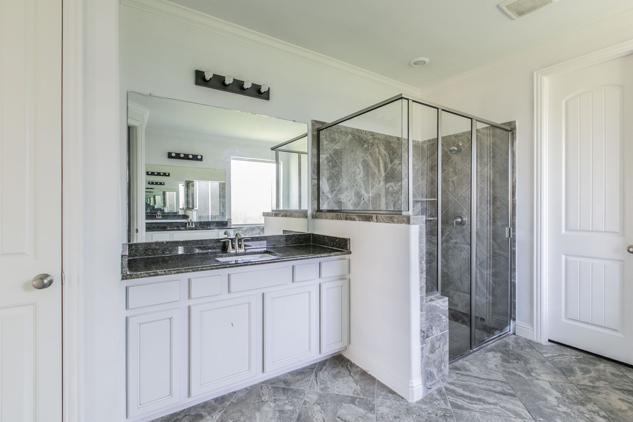 4806 Timber Gate Court Rosharon, TX 77583 - Photo 17 of 36 a bathroom with a granite countertop sink a mirror and a shower