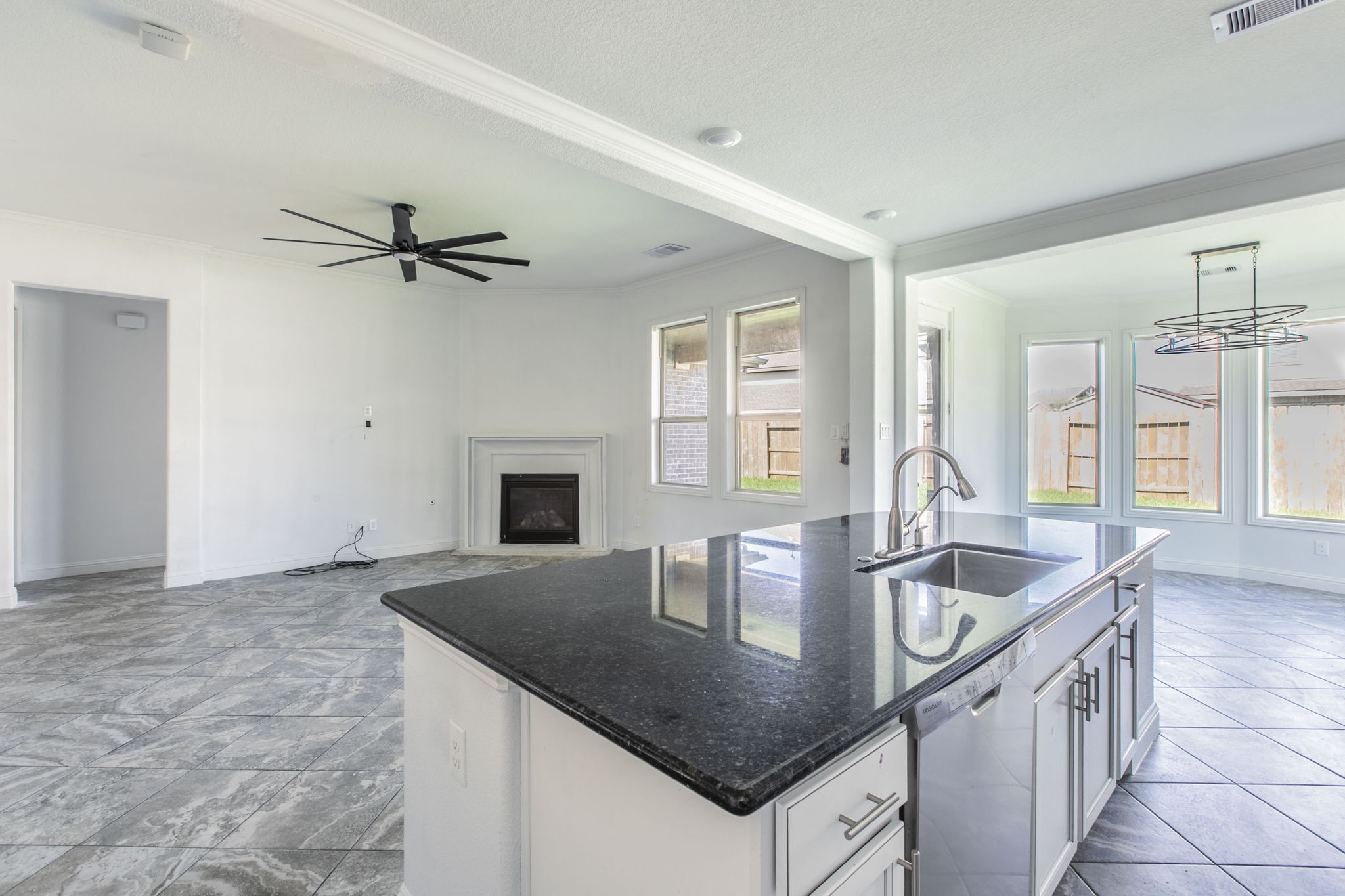 4806 Timber Gate Court Rosharon, TX 77583 - Photo 20 of 36 a kitchen with granite countertop a sink a counter top space and living room