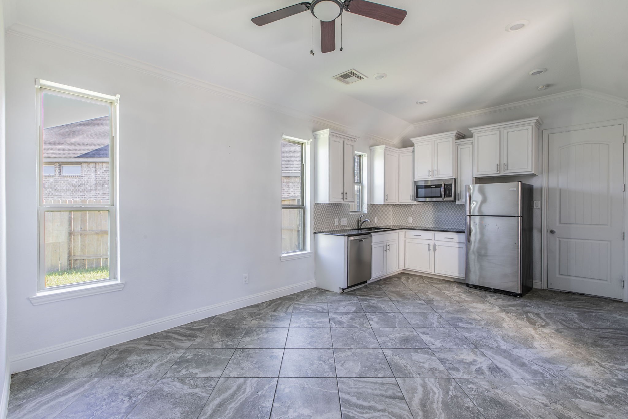 4806 Timber Gate Court Rosharon, TX 77583 - Photo 26 of 36 a kitchen with stainless steel appliances a refrigerator sink and cabinets