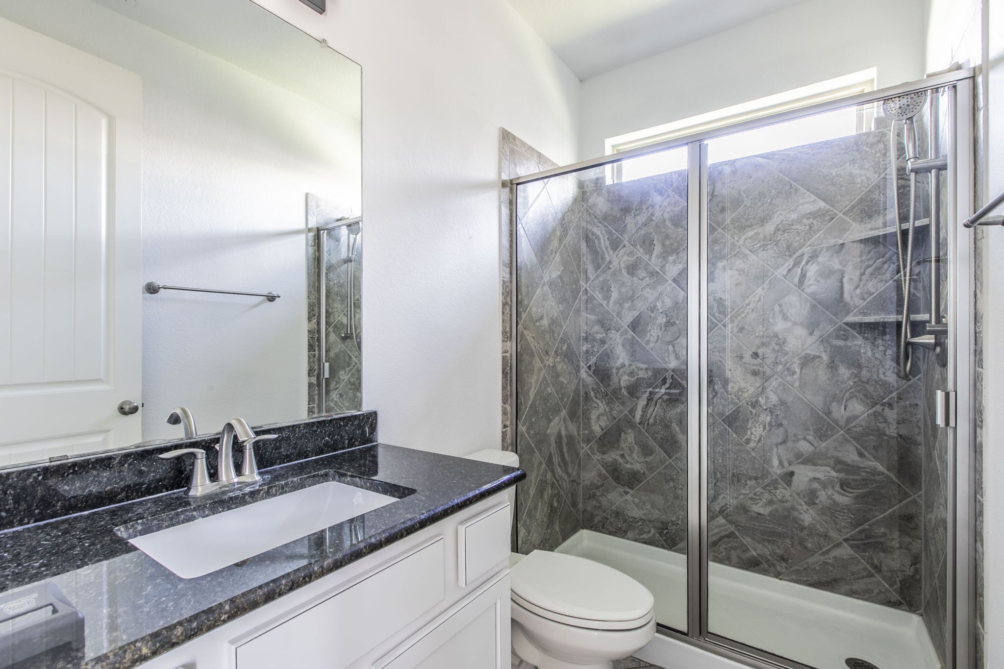 4806 Timber Gate Court Rosharon, TX 77583 - Photo 28 of 36 a bathroom with a granite countertop sink toilet and shower