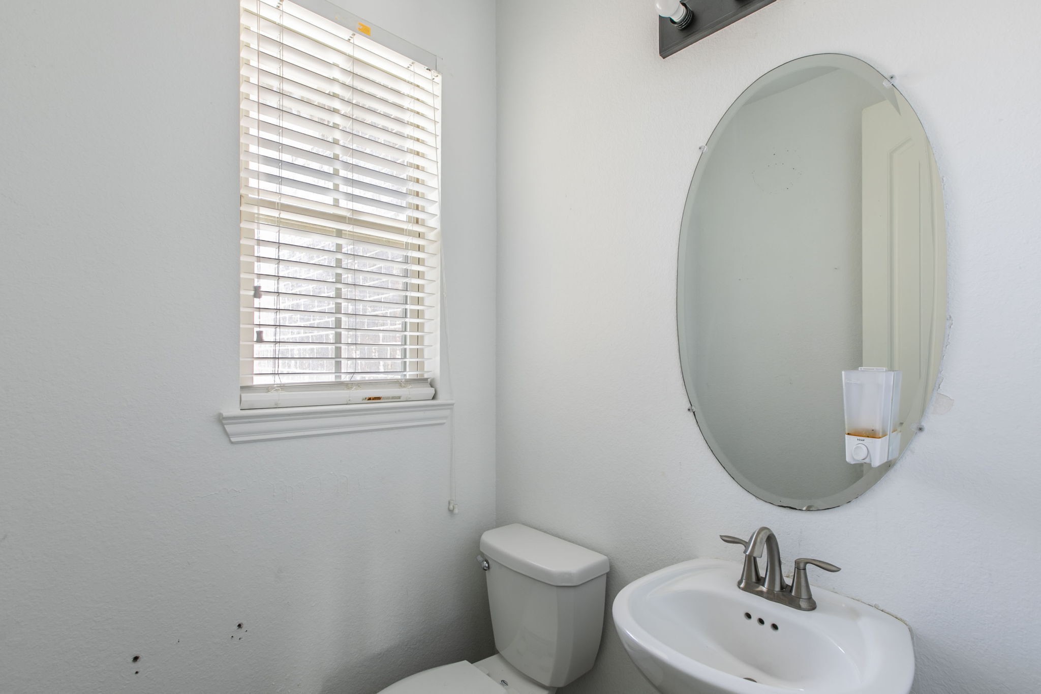 4806 Timber Gate Court Rosharon, TX 77583 - Photo 8 of 36 a bathroom with a toilet sink and mirror
