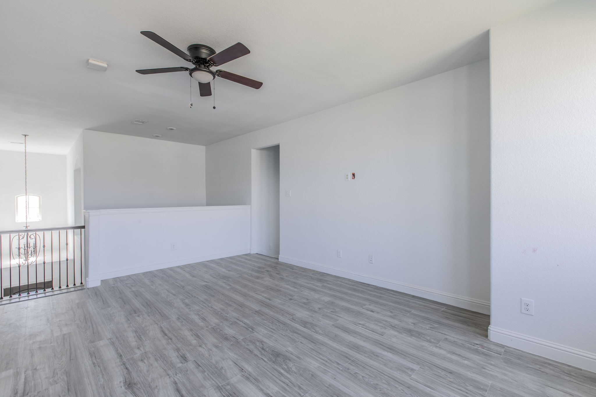 4806 Timber Gate Court Rosharon, TX 77583 - Photo 9 of 36 an empty room with wooden floor fan and windows